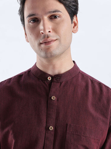 Castlevania: Stylish man wearing a burgundy linen shirt from Turms Intelligent Apparel, showcasing its quality and design.