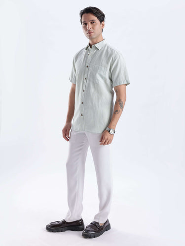 Man wearing a Limey Cream linen shirt, featuring premium, waterproof, anti-odour, and anti-stain properties.