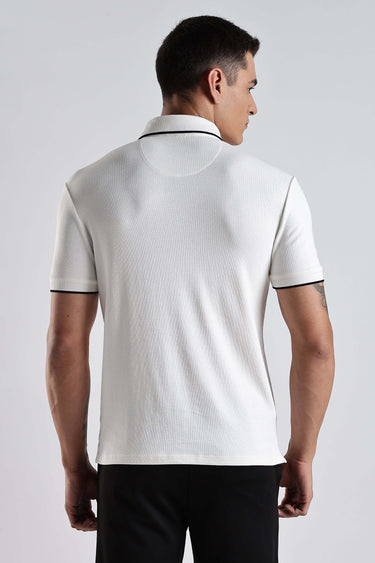 Back view of a man wearing the White Owl cotton polo tshirt with premium comfort and style.