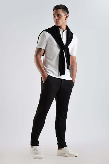 Model wearing a White Owl premium cotton polo t-shirt paired with stylish pants and shoes.