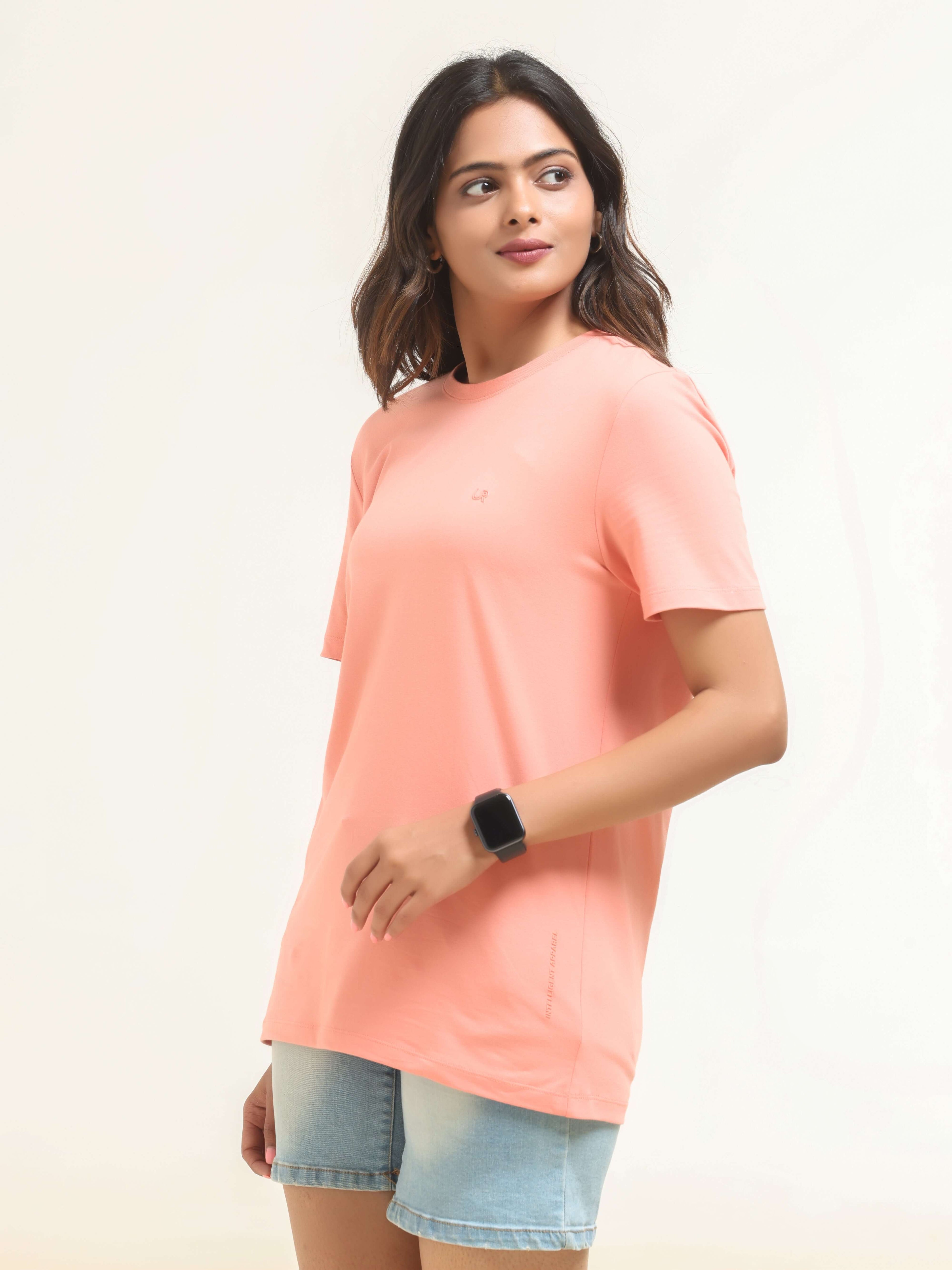Woman wearing Sunset Spice colored round-neck Turms T-shirt, showcasing tailored fit and premium cotton blend fabric.