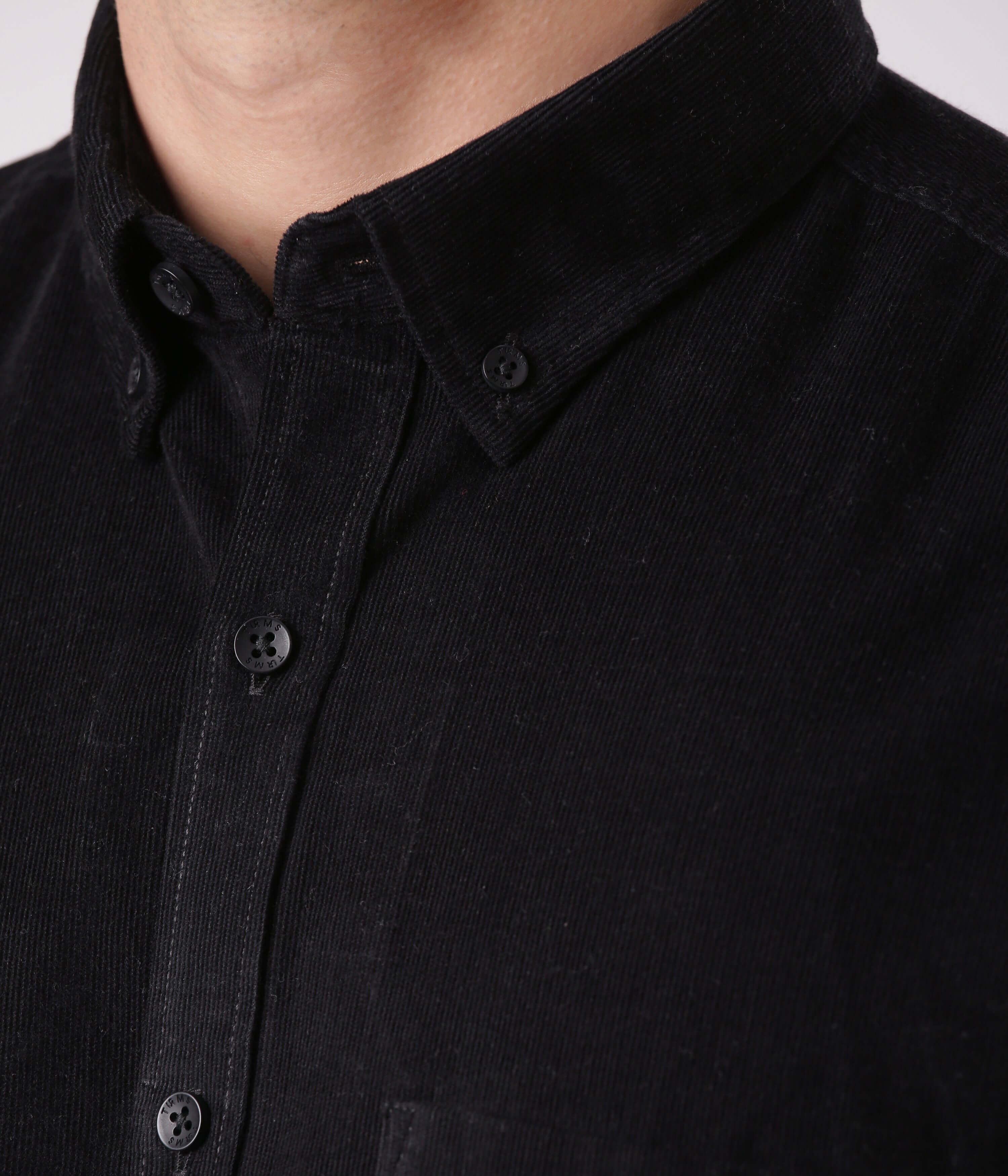 Black Beauty - close-up of Turms corduroy shirt in black, showcasing quality fabric and button details.