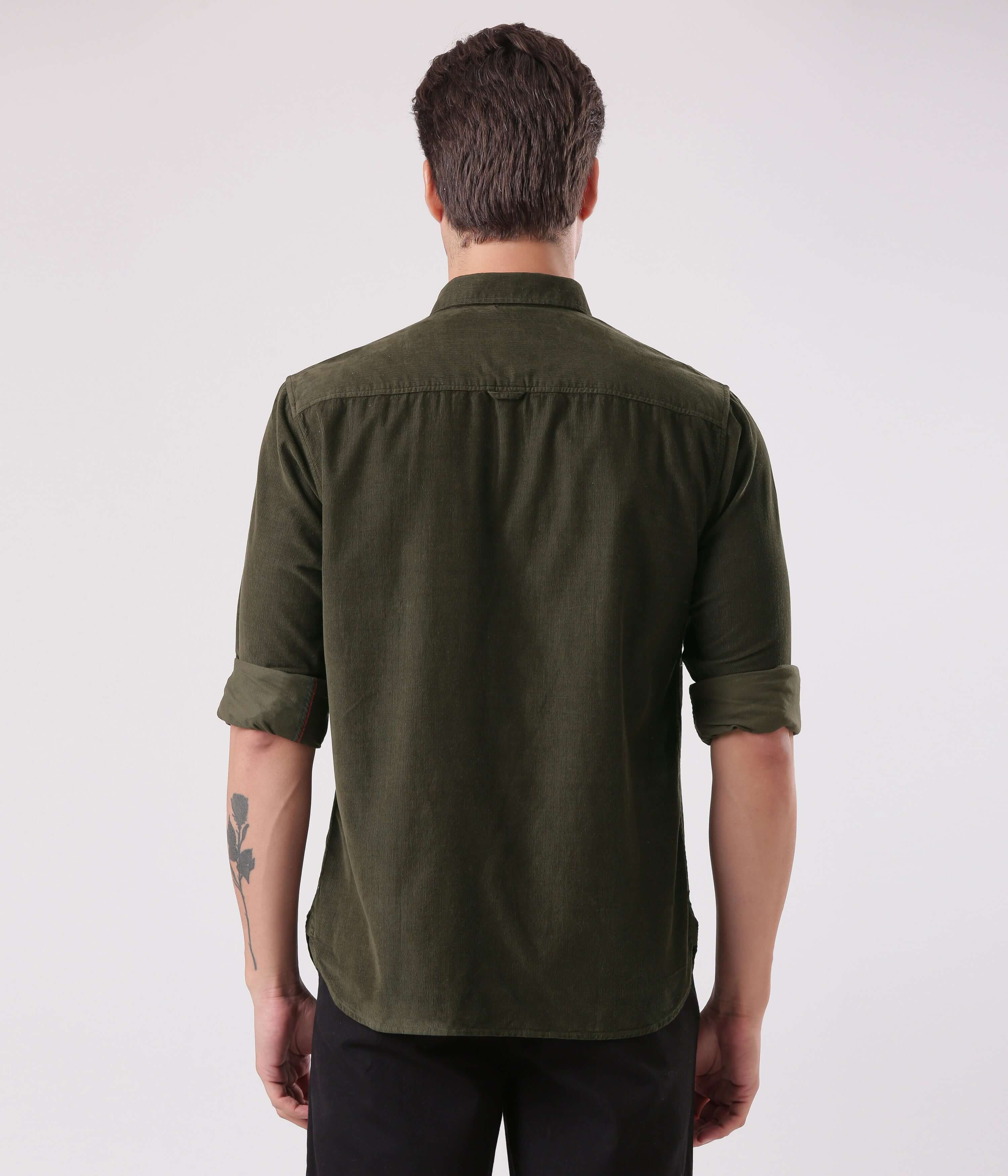 Back view of a man wearing the Emerald Star corduroy shirt, showcasing its stylish design in dark green.