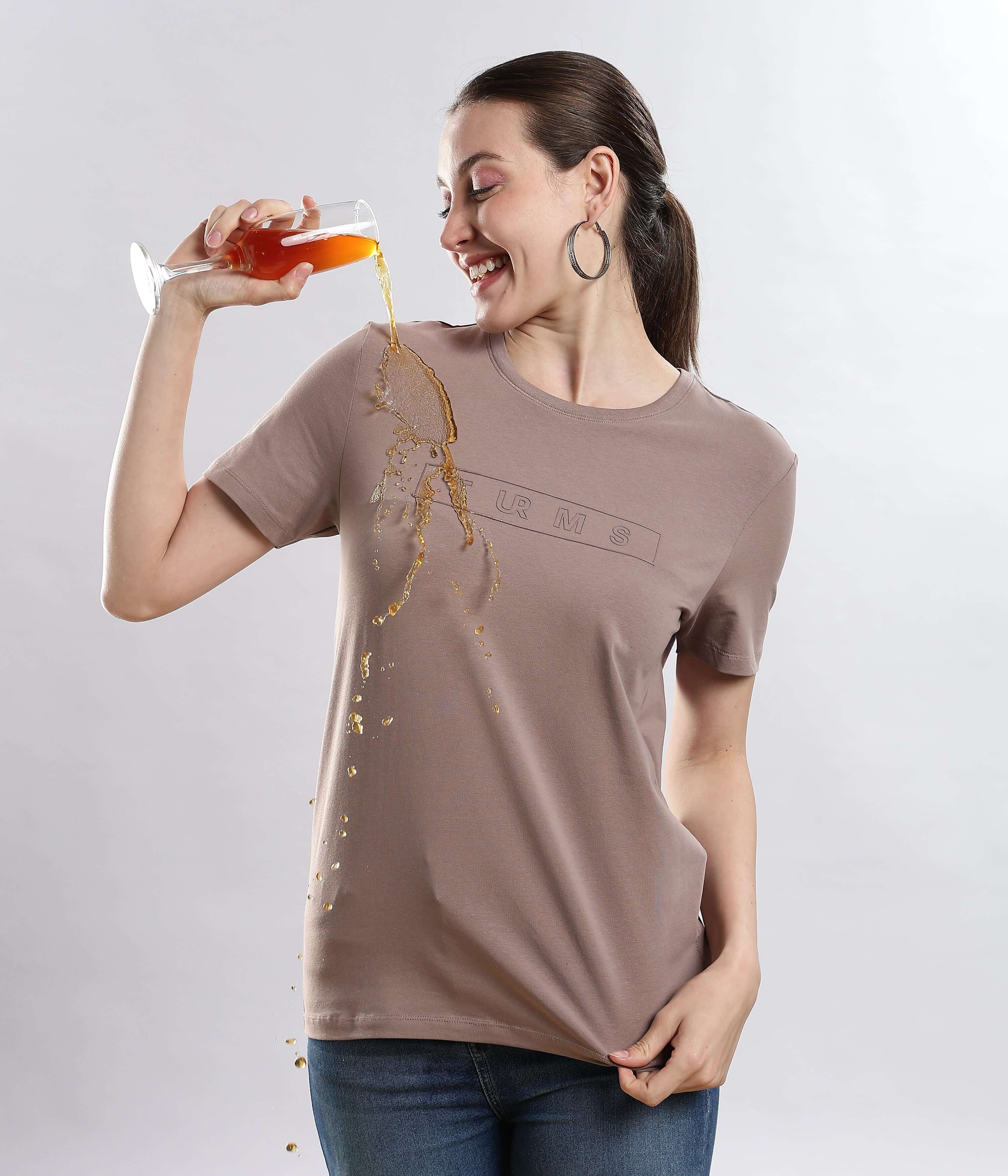 Woman enjoying a drink while wearing the Womens casual t-shirt Garnet Brown Turms Worry-Free Intelligent T-Shirt, showcasing its water-proof feature.