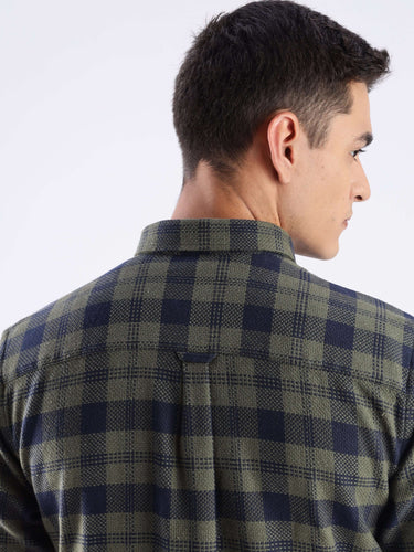 Back view of a man wearing the Turms recycled cotton checked shirt in olive green, showcasing its stylish design and durability.