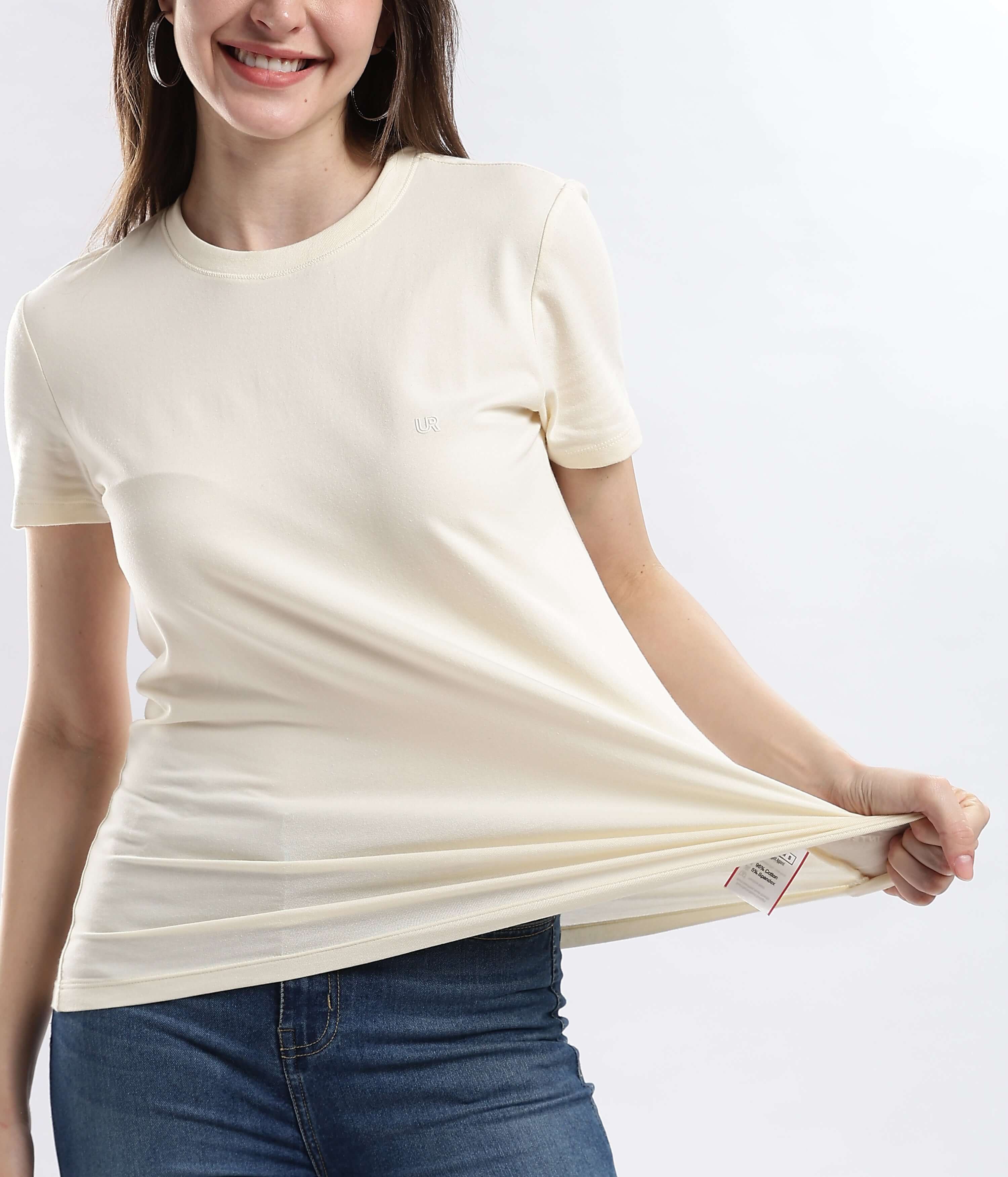Woman wearing a Polar Off-white cotton t-shirt, showcasing its stretchable and water-proof features.