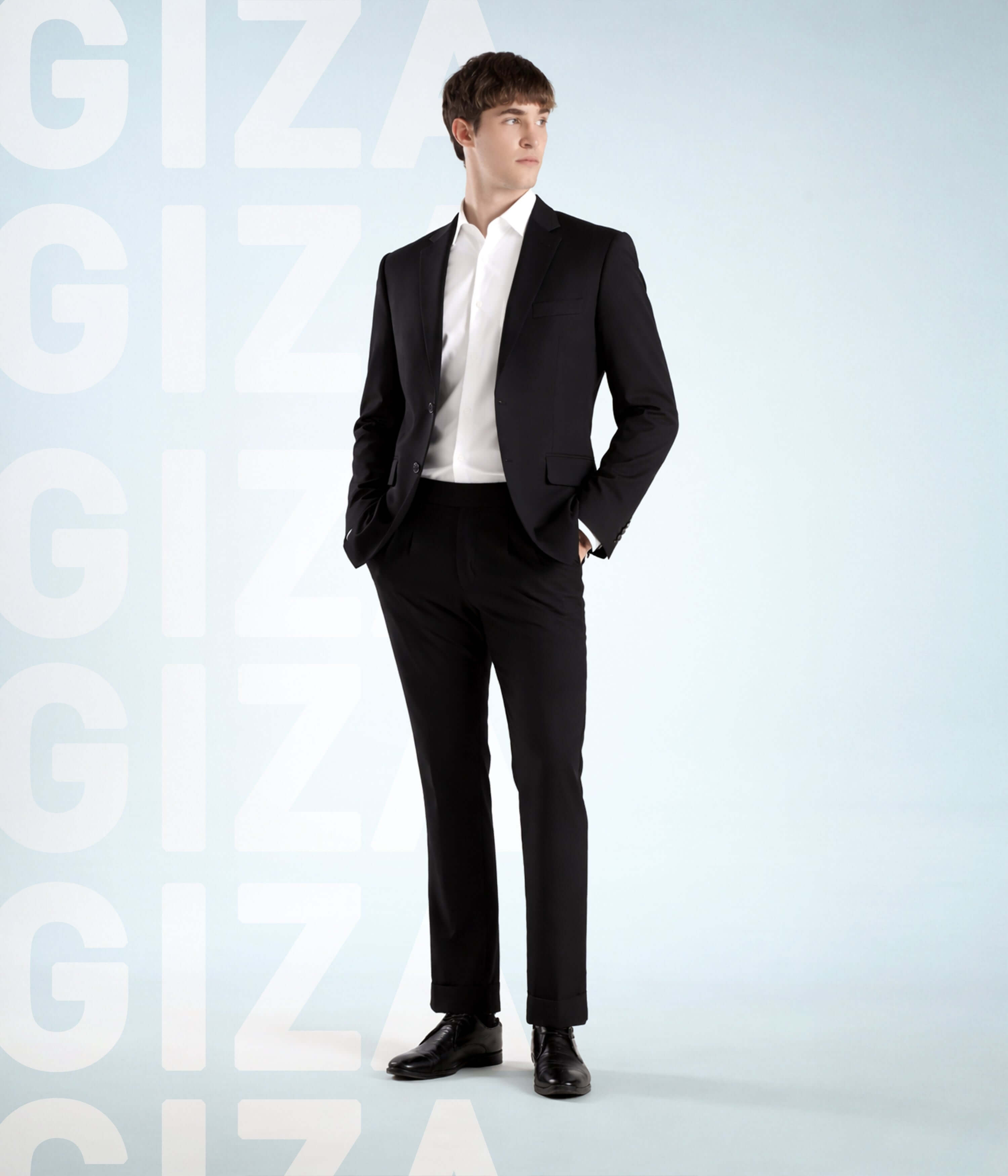 Model wearing Elite White shirt and black suit showcasing Giza cotton elegance.