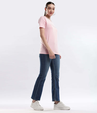 Model wearing Womens casual t-shirt Quartz Pink cotton tshirt with denim jeans, showcasing its stretchable, waterproof, and anti-odour features.