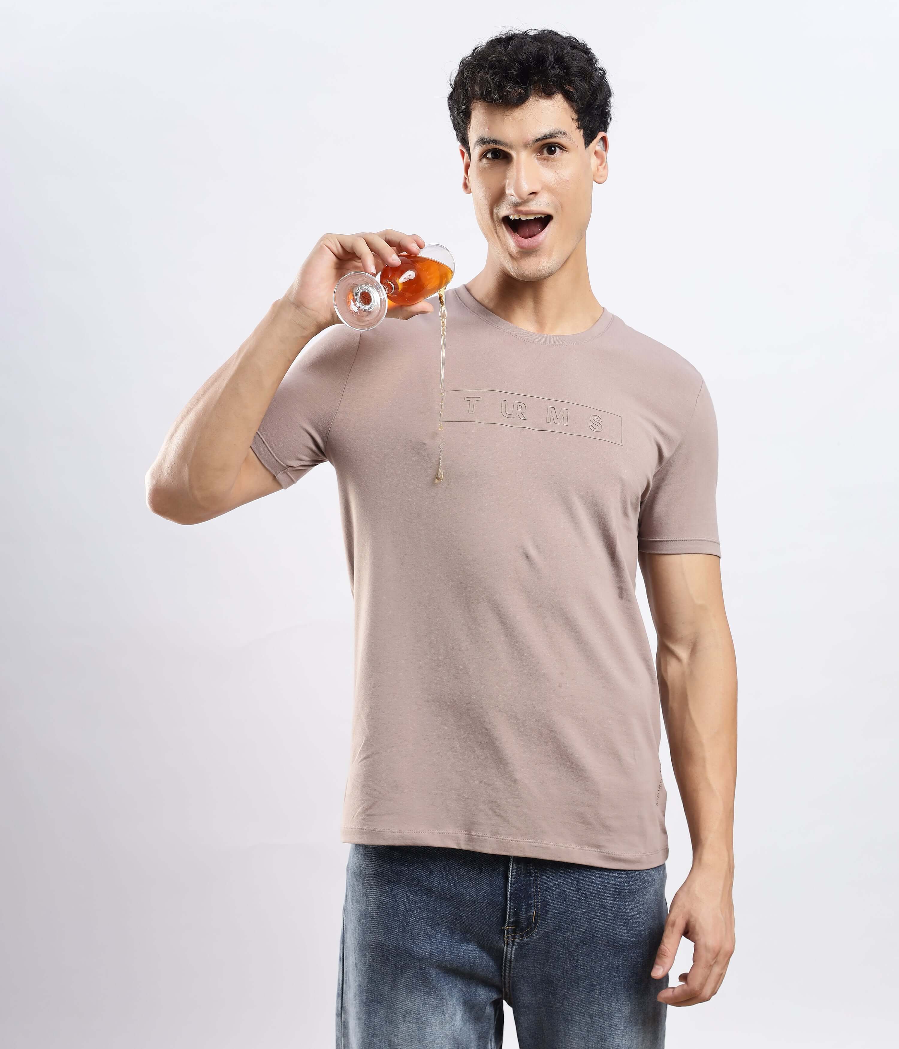 Model wearing a Garnet Brown cotton tshirt, showcasing its stretchable and waterproof design while enjoying a drink.