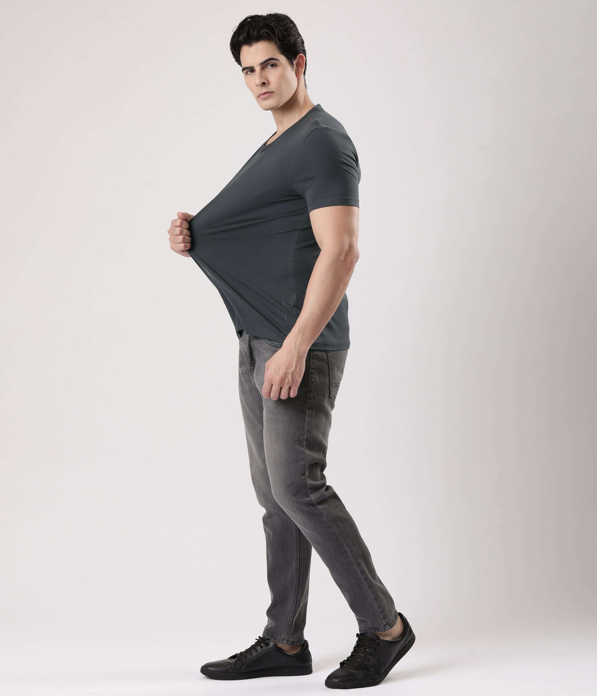 Man showcasing the Charcoal Knight Turms Intelligent T-Shirt in a casual outfit, ideal for stylish comfort.