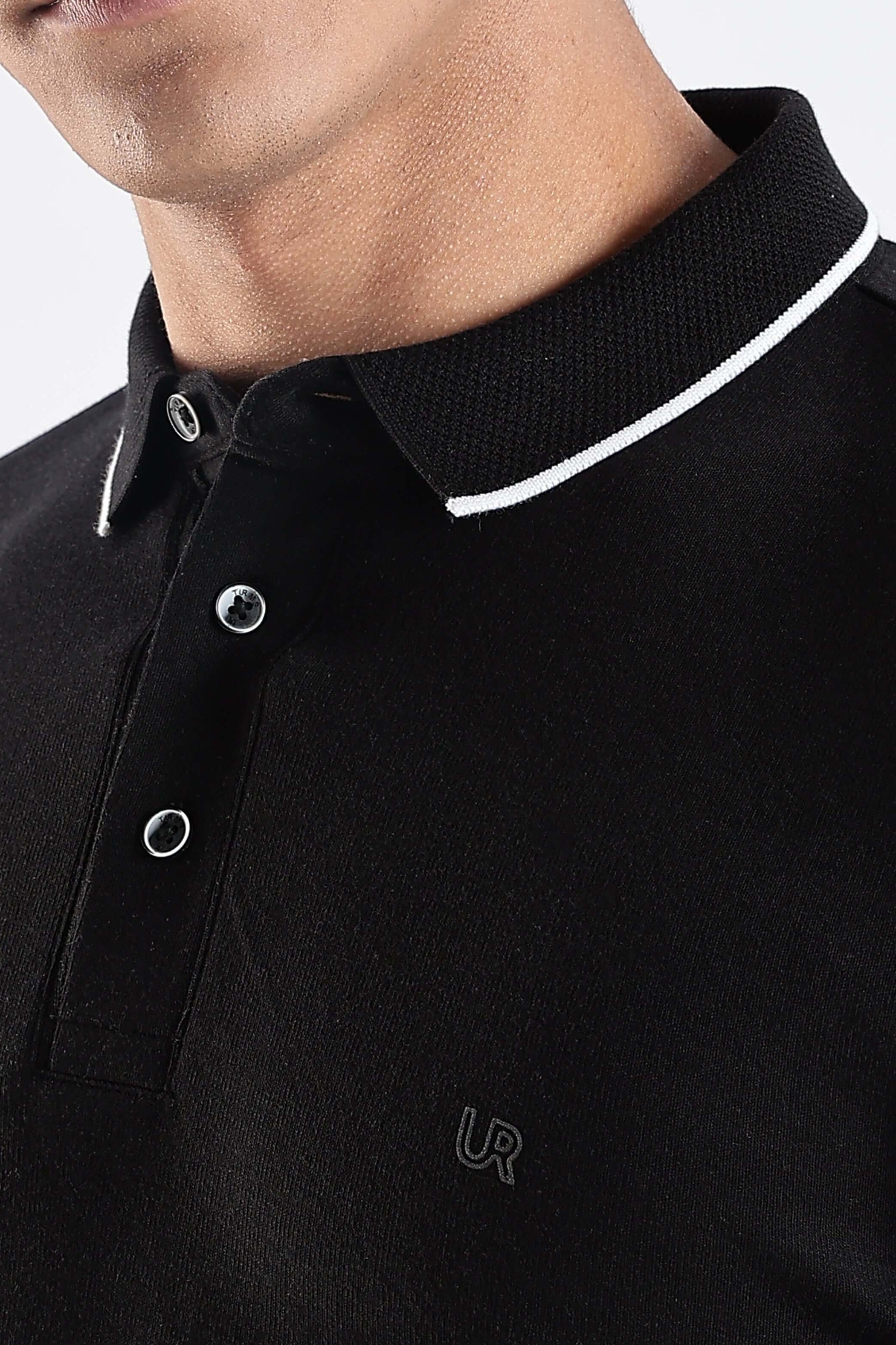 A close-up of a man wearing a Black Primal cotton polo t-shirt with a stylish collar and buttons, highlighting its premium quality.