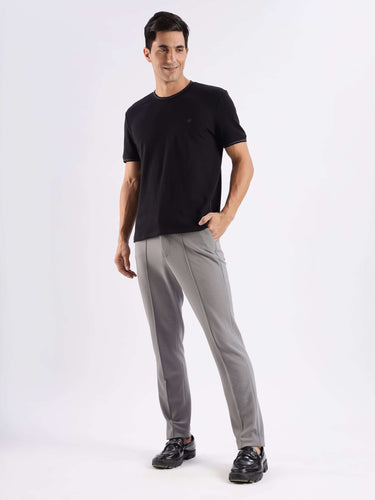 Man wearing a Mandalorian black CoolTech t-shirt with 8-way stretch, paired with stylish gray pants.