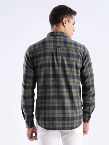 Back view of a man wearing a Turms recycled cotton checked shirt in olive and navy, showcasing sustainable fashion.