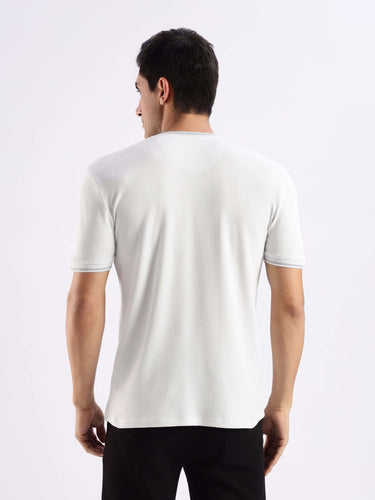 Rear view of a man wearing a Turms Intelligent Ice Cool Tech T-Shirt in grey, emphasizing its breathable, 8-way stretch fabric.
