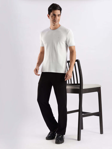 Man wearing Nova Grey knitted shirt with 8-way stretch and temperature control features, paired with black pants.