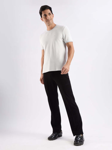 Man wearing Nova Grey Turms Ice Cool Tech T-Shirt, stylish knitted shirt with 8-way stretch and anti-odour features.