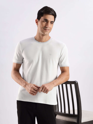 Man wearing a premium white Turms Intelligent Ice Cool Tech T-Shirt, featuring 8-way stretch and anti-odor technology.