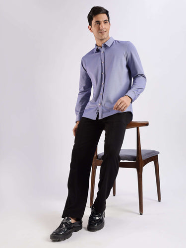 Model wearing a blue pine Turms Intelligent Knitted Shirt with 8-way stretch, offering anti-odour and stain-resistant features.