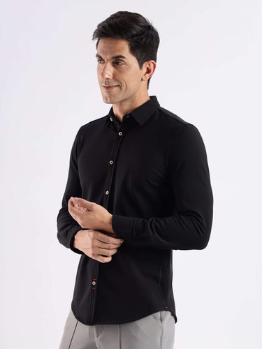 Man wearing the Venice Black knitted shirt, a premium 8-way stretch, anti-odour and stain-resistant shirt.