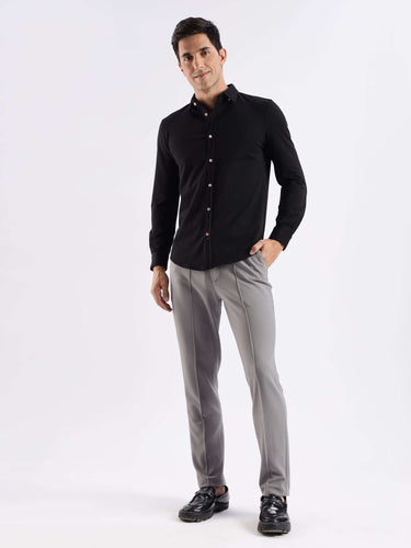 Man wearing Venice Black knitted shirt featuring 8-way stretch, anti-odour, and premium quality for stylish comfort.