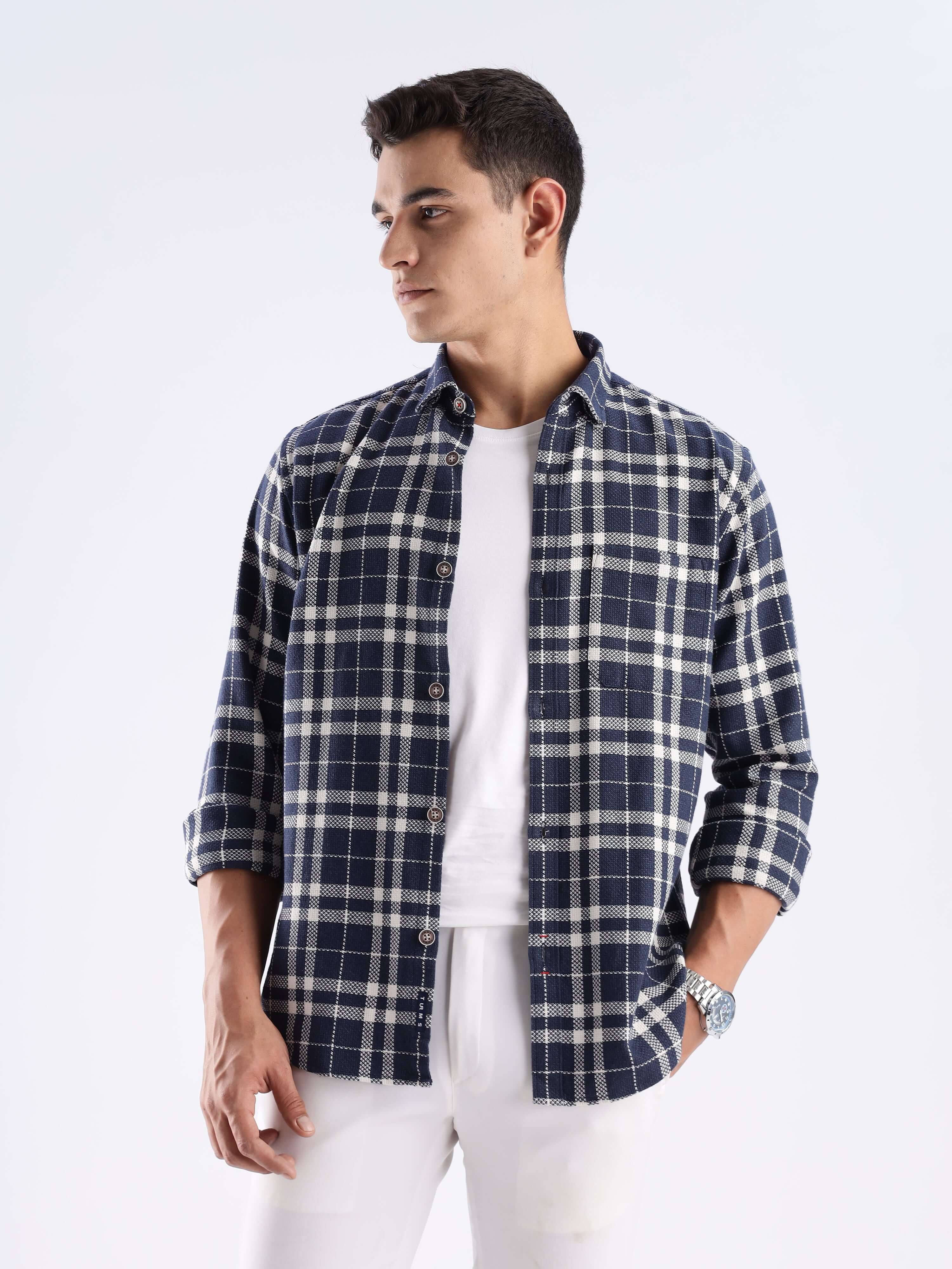 Man wearing Andromeda Turms recycled cotton checked shirt, showcasing sustainable fashion with a stylish design.