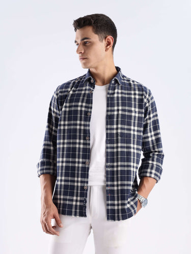 Man wearing Andromeda Turms recycled cotton checked shirt, showcasing sustainable fashion with a stylish design.