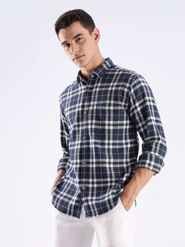 Stylish man wearing Andromeda Turms recycled cotton checked shirt, showcasing sustainable fashion and cool tech features.