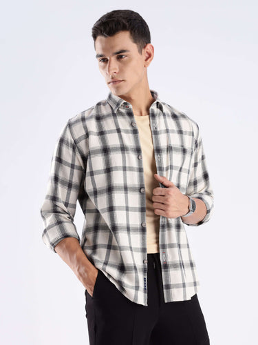 Man wearing a sustainable recycled cotton checked shirt in a stylish pose, showcasing its cool tech features.