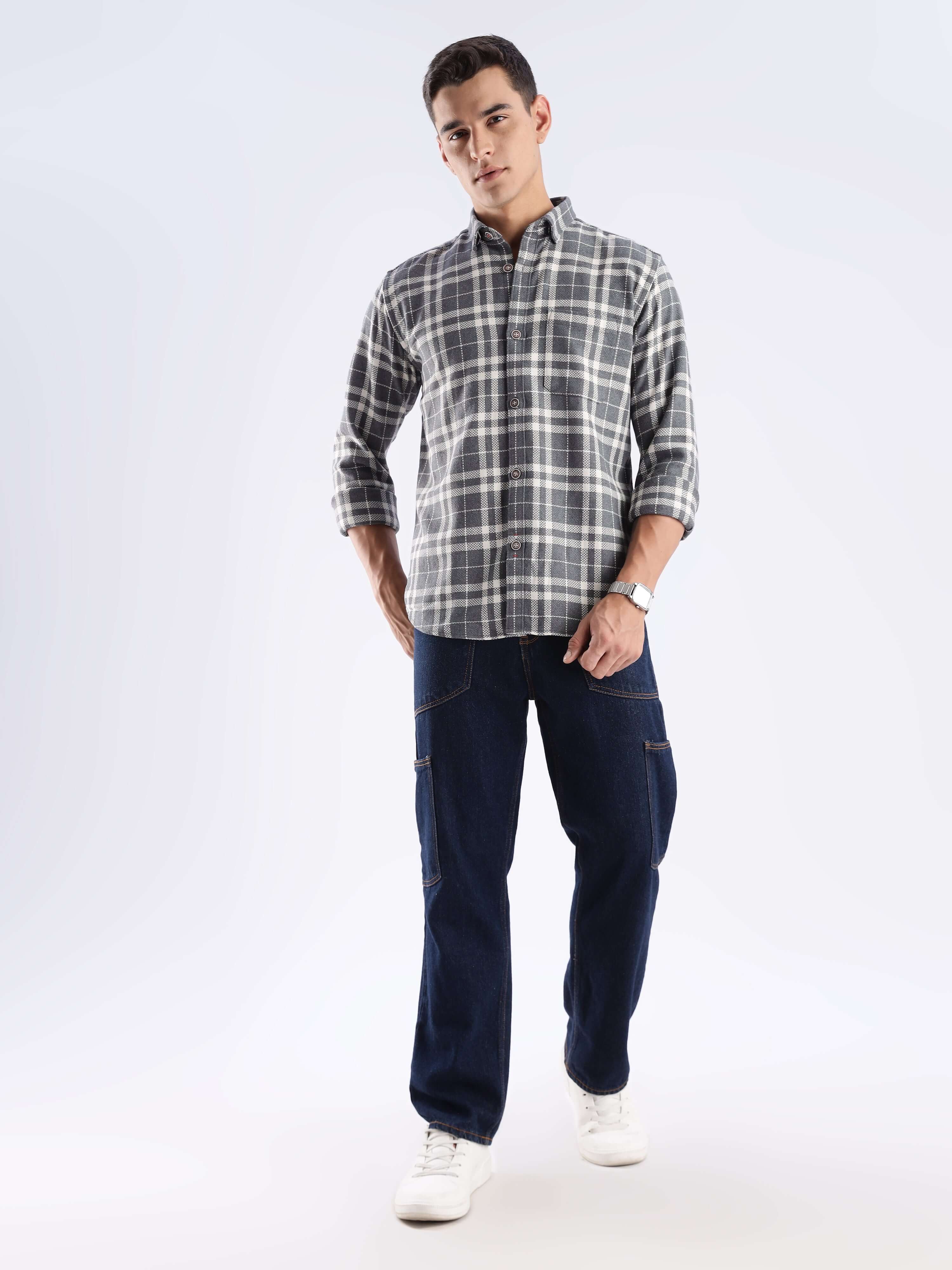 Man wearing a stylish recycled cotton checked shirt and navy pants, showcasing sustainable fashion.