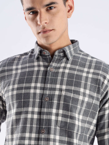Stylish man wearing the Turms recycled cotton checked shirt, showcasing its sustainable fabric and modern design.