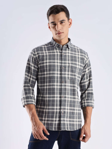 Man wearing a Turms recycled cotton checked shirt, showcasing stylish design and sustainable fashion.