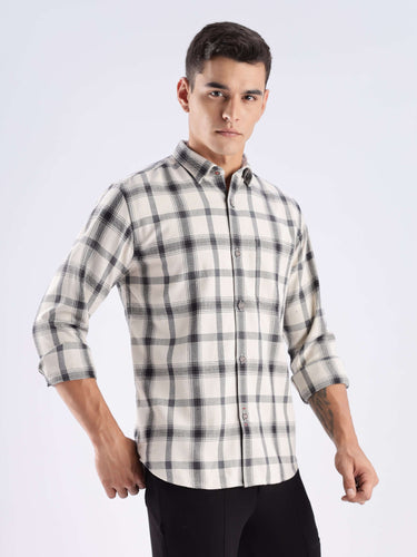 Man showcasing a stylish recycled cotton checked shirt with cool tech features, emphasizing sustainability and durability.