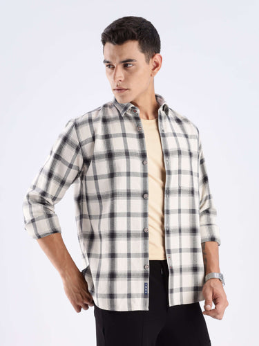 Stylish male model wearing a Turms recycled cotton checked shirt, showcasing sustainable fashion and a cool-tech feature.