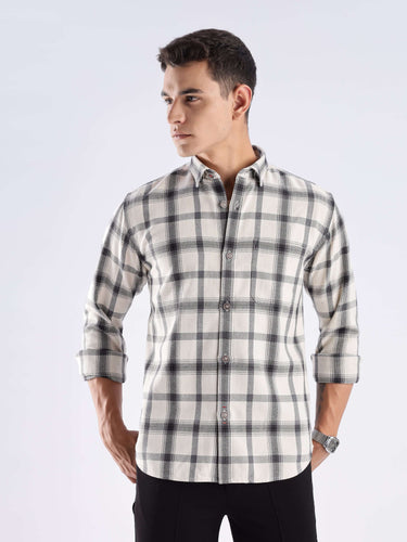 Stylish male model wearing Turms recycled cotton checked shirt, showcasing sustainable fashion and cool tech features.