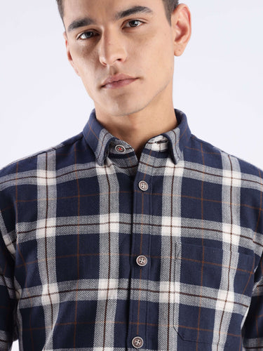 Model wearing the Blue Arkham Turms recycled cotton checked shirt in navy and white, showcasing style and sustainability.