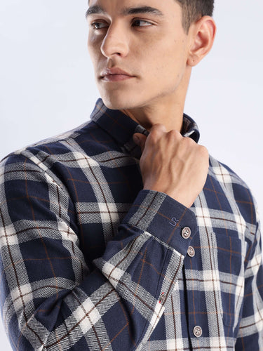 Man wearing the Blue Arkham Turms Recycled Cotton Checked Shirt, showcasing sustainable style and cool tech features.