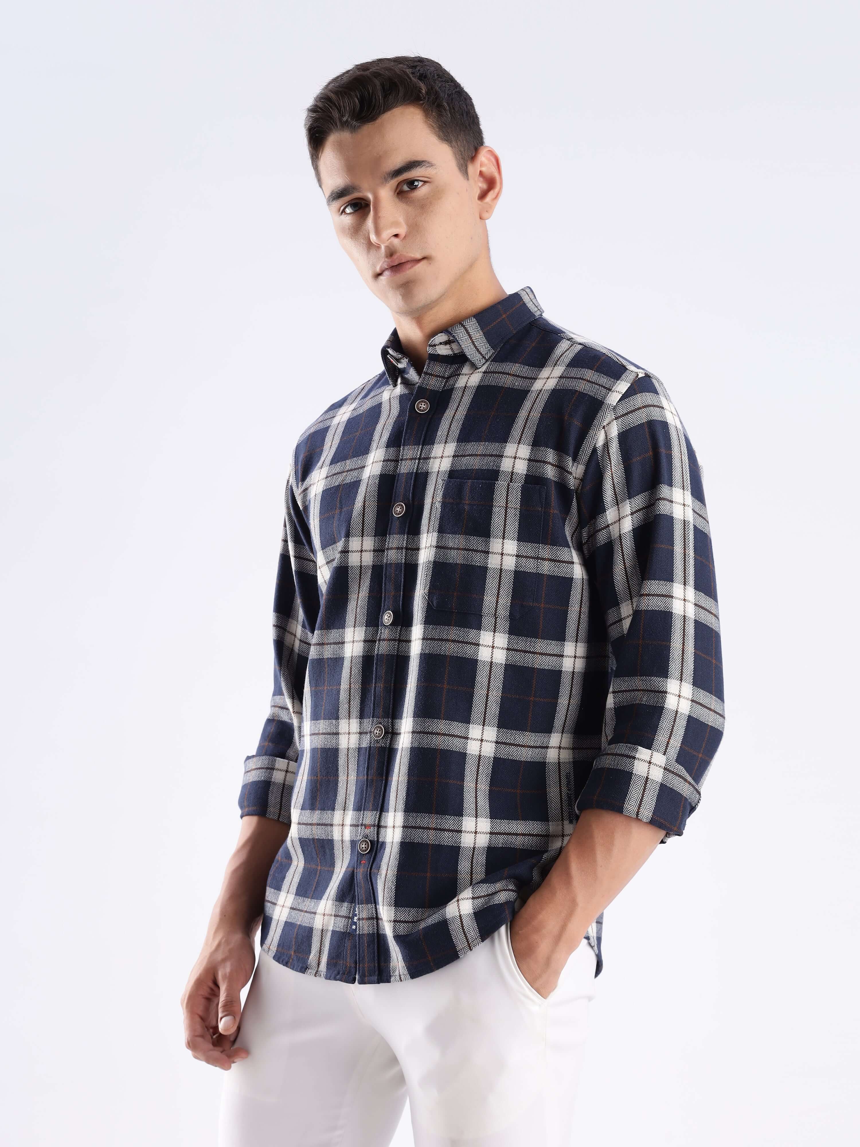 Stylish man wearing a blue checked shirt made from recycled cotton, showcasing sustainable fashion with anti-odour technology.