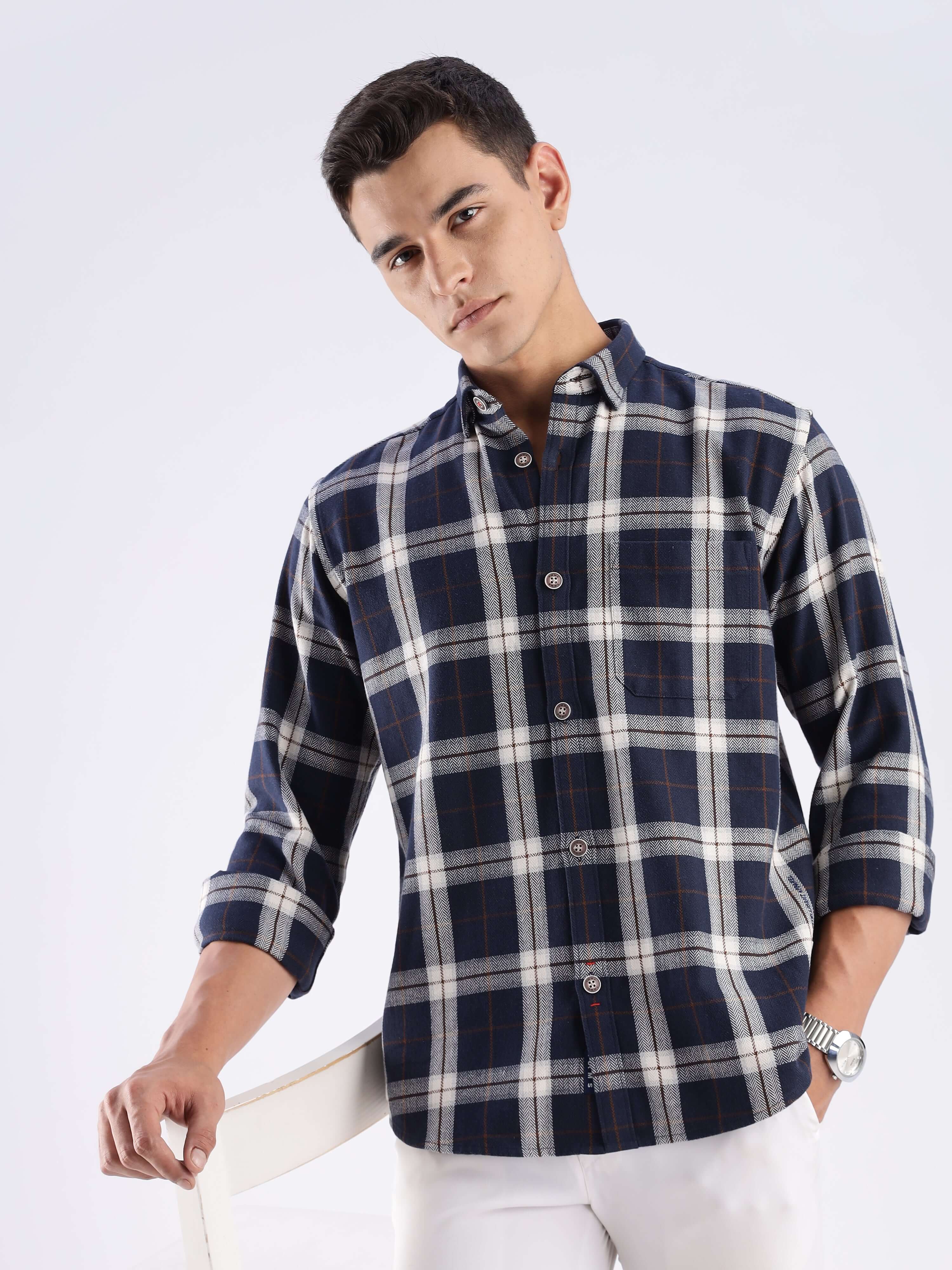 Model wearing a blue and white checked sustainable cotton shirt by Turms, showcasing eco-friendly fashion.