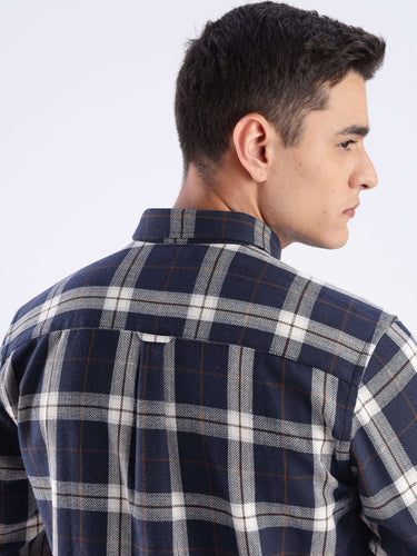 Back view of a man wearing the Blue Arkham Turms recycled cotton checked shirt, showcasing sustainable fashion.