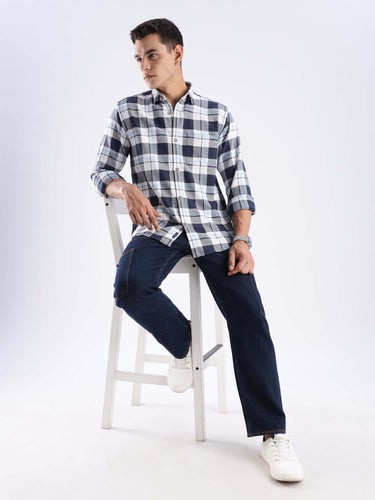 Man wearing a blue checked recycled cotton shirt, showcasing sustainable fashion and cool tech features.