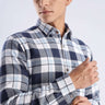 Model wearing a blue and white checked recycled cotton shirt, showcasing sustainable fashion and stylish design.