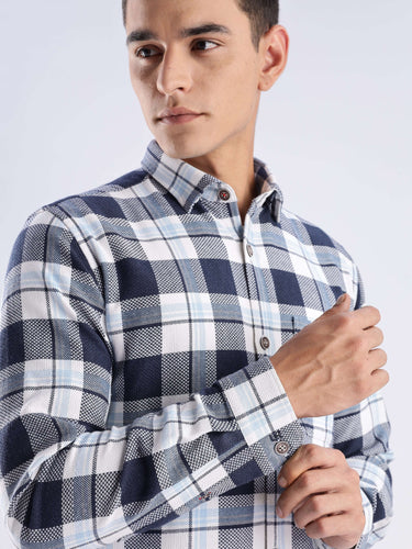 Model wearing a blue and white checked recycled cotton shirt, showcasing sustainable fashion and stylish design.