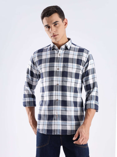 Man wearing a blue recycled cotton checked shirt, stylish and sustainable, perfect for everyday luxury.