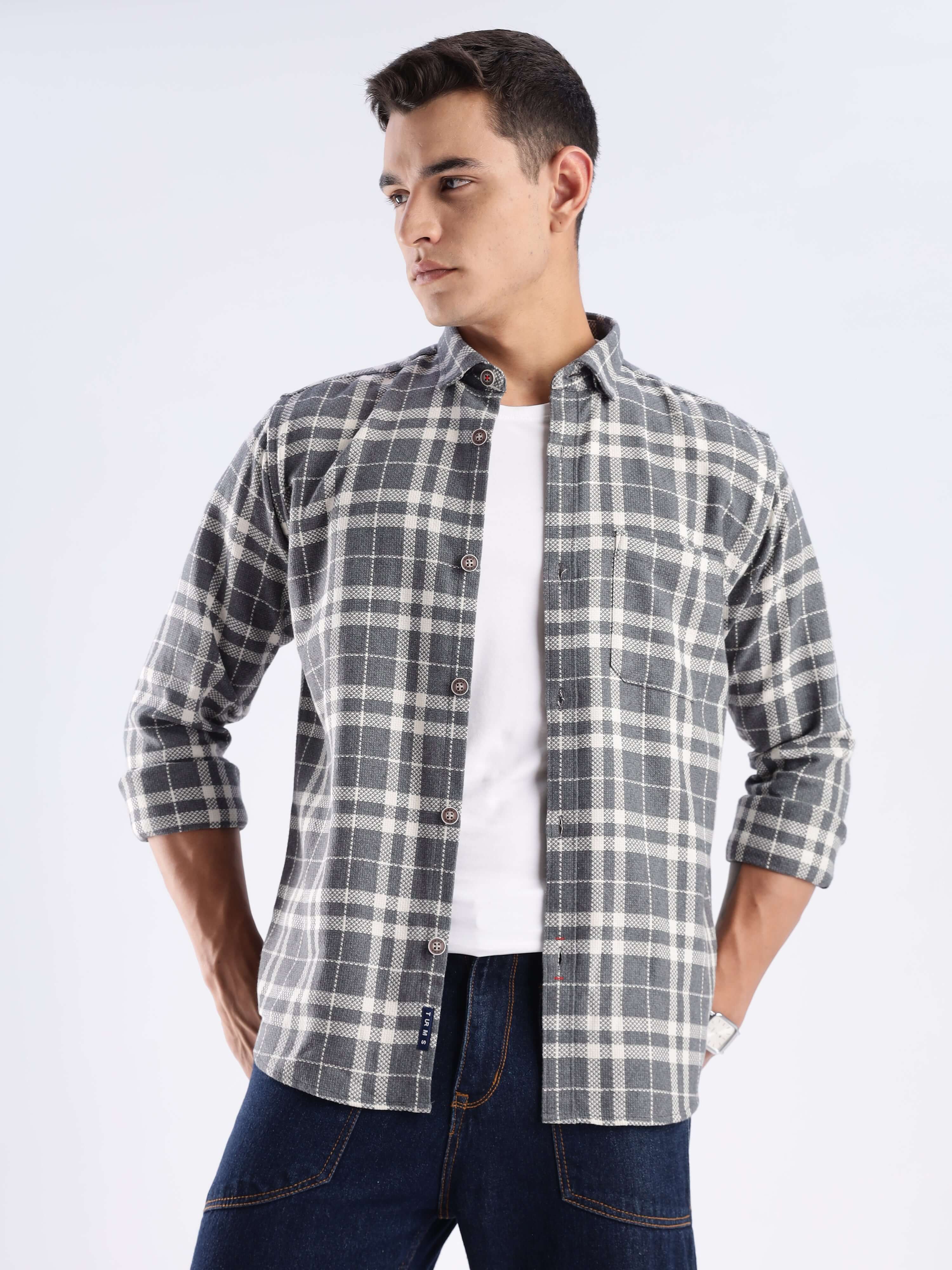Model wearing a Turms recycled cotton checked shirt, showcasing sustainable fashion with a stylish pattern.