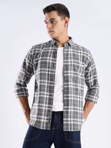 Model wearing a Turms recycled cotton checked shirt, showcasing sustainable fashion with a stylish pattern.