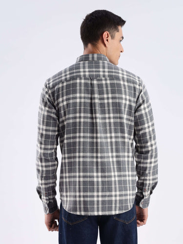 Back view of a man wearing a Turms recycled cotton checked shirt, showcasing its stylish and sustainable design.