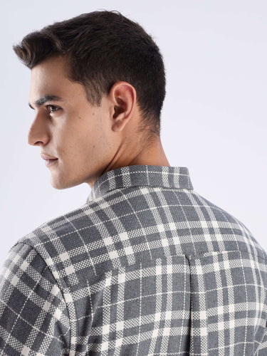 Close-up of man wearing Turms recycled cotton checked shirt, showcasing sustainable fashion with a stylish design.