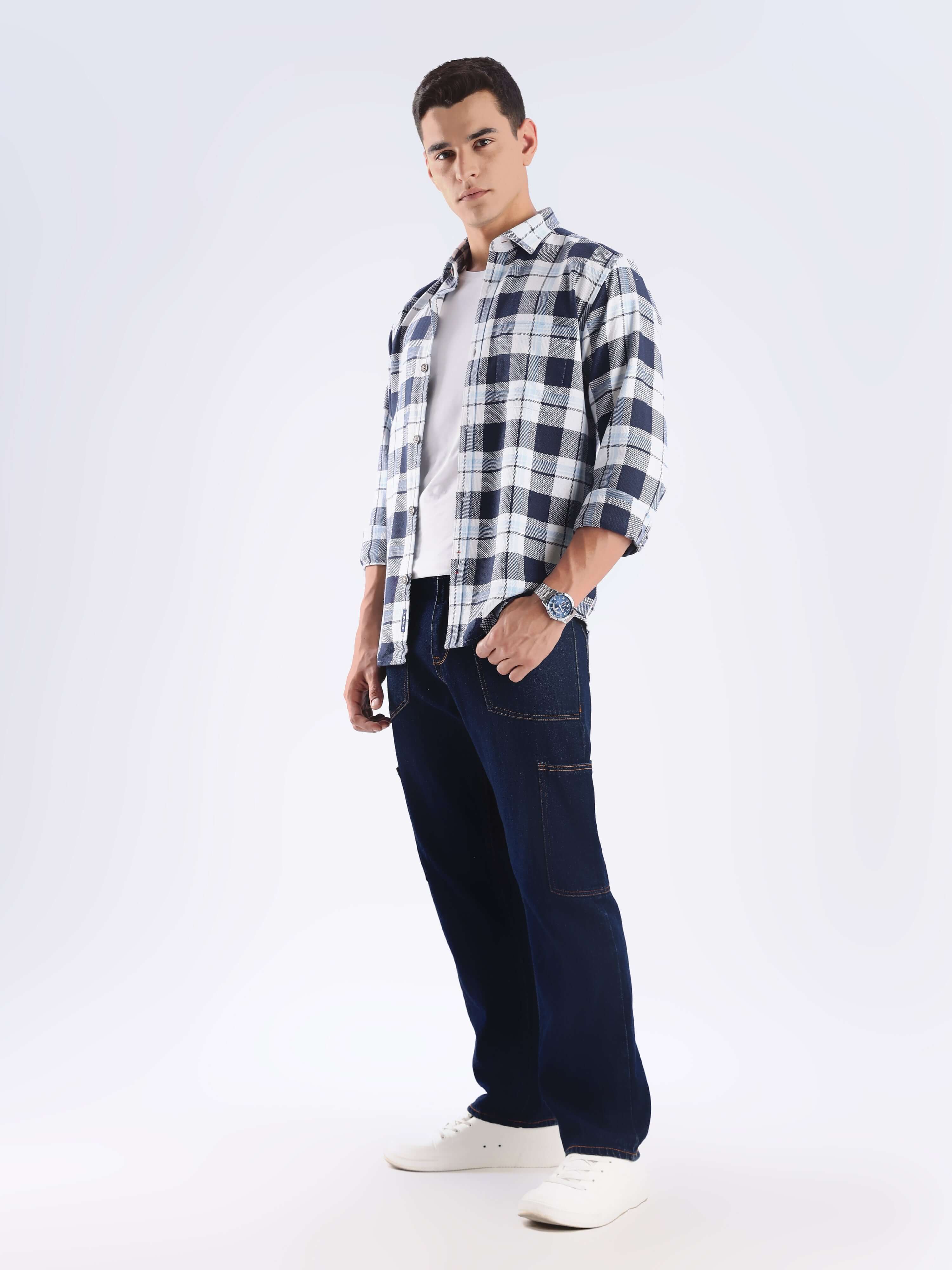 Model showcasing the sustainable Turms recycled cotton checked shirt with casual trousers and sneakers.