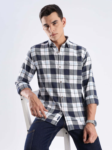 Man wearing Turms recycled cotton checked shirt, showcasing sustainable fashion with anti-odour cool tech feature.