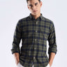 Man wearing a sustainable recycled cotton shirt in a green check pattern, showcasing style and functionality.